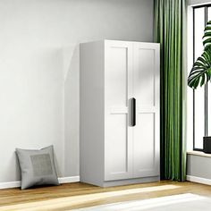 an empty room with green curtains and a white cabinet next to a potted plant