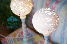 two white lamps sitting on top of a table