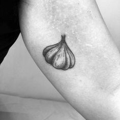 a black and white photo of an onion tattoo