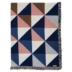 a multicolored blanket with fringes on the bottom and an image of triangles