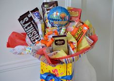 a gift basket filled with candy, candies and other items for someone's birthday