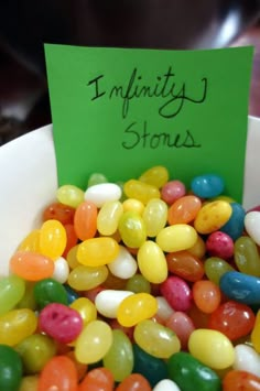 jelly beans in a white bowl with a green sign that says, i'm limitity stones