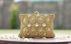 Introducing our exquisite Metallic Golden Clutch, a true work of art meticulously handcrafted to elevate your style. This stunning piece combines the elegance of a ladies' purse with the charm of handmade gifts and the allure of vintage fashion. Made with care and attention to detail, this handcrafted bag embodies the essence of luxury. Its golden hue exudes opulence and pairs perfectly with sarees, adding a touch of glamour to your ethnic ensemble. The intricate metal clutch design showcas Golden Clutch, Clutch Design, Indian Gifts, Ladies Bag, Gold Clutch, Wedding Clutch, Ladies Purse, Handcrafted Bags, Art Antique