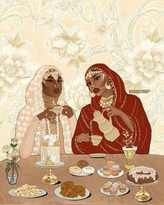 two women sitting at a table with food on it