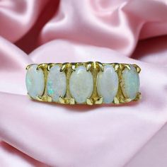 FREE SAME DAY SHIPPING & GIFT WRAPPING! A beautiful Antique victorian Five Stone Prong Opal Ring! This alluring 14kt gold antique ring holds 5 approximate 5x3.5mm opals along a stylish prong setting. The whites opal are simply mesmerizing, displaying an array of iridescent colors that flash and shimmer! A variety of colorful shades are included in the color play, almost seeming to glow from within. Completing the design are the sleek shoulders, which extend to a smooth gold band in the back. A s 14k Gold Opal Ring, Natural Opal Ring, Anniversary Gift For Wife, Opal Ring Gold, Color Play, Antique Ring, Emerald Pendant, Anniversary Gifts For Wife, October Birthstone