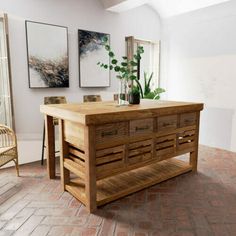 a large wooden table sitting in the middle of a room with pictures on the wall