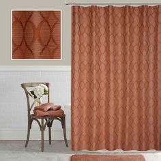 an orange shower curtain next to a brown chair and white flower on a pink rug