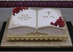 a cake decorated with an open book and roses