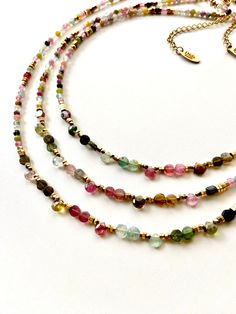 Fine and original handmade gemstone necklace choker beaded with faceted multi tourmaline stones and 18k. gold filled hematite beads. The central part of necklace is decorated with very beautiful multicolore round flat tourmaline and drop of tourmaline stones. Thanks to the different natural shades of multi-colored tourmaline this necklace will fit perfectly with all your outfits. Original and unique creation, great gift idea for women. Necklace assembled on a very durable jewelry wire. Adjustable length 15.7 inch. + 2 in extension chain. Nickel-free stainless steel lobster clasp. Diameter of stones 3-4mm. Bohemian Beaded Tourmaline Jewelry, Multicolor Beaded Tourmaline Jewelry, Multicolor Tourmaline Beaded Jewelry, Handmade Multicolor Tourmaline Necklaces, Bohemian Multicolor Tourmaline Necklaces, Multicolor Tourmaline Beaded Necklace With Faceted Beads, Multicolor Faceted Tourmaline Necklaces, Multicolor Tourmaline Faceted Beads Necklace, Multicolor Faceted Tourmaline Bead Jewelry