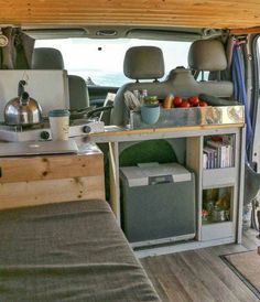 the interior of a camper van with its bed pulled out