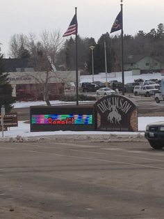 a police car is parked in front of the sign