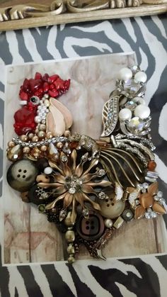 there are many different types of brooches in this picture on the zebra print table cloth