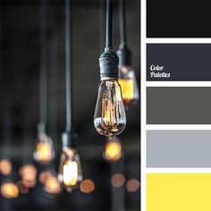 several light bulbs are hanging from the ceiling with yellow and gray colors on them,