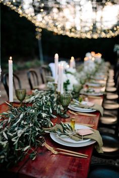 the table is set with candles and plates