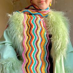 a woman wearing a multicolored knitted scarf