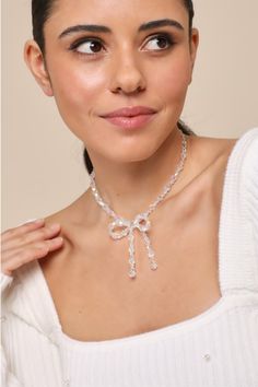 Everyone will bow down to your cute aesthetic when you wear the Lulus Sweetest Potential Clear Beaded Bow Choker Necklace! This adorable necklace features shiny, iridescent clear beads (in varying sizes) that form a choker silhouette that boasts an oversized bow detail at the center. Gold hardware throughout. Lobster clasp closure. Chain measures 11. 75" Long. Extender chain 3" long. 100% Acrylic. Imported. Lulus | Sweetest Potential Clear Iridescent Beaded Bow Choker Necklace. Adjustable Clear Necklace For Party, Clear Necklace, Bow Choker, Beaded Bow, Traditional Engagement Rings, Clear Beads, Bow Necklace, Photoshoot Inspo, Your Cute