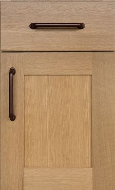 a close up of a door handle on a wooden cabinet