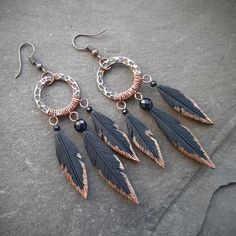 These statement long black feather earrings are hand-sculpted of polymer clay and decorated with hammered copper rings and agate beads. Can make a perfect little gift for women who love Gothic or witch aesthetic. Can also be a part of a Halloween outfit or used for everyday wear. Earring length 3 inches (from the top of the ear wire) Drop length 2 1/2 inches Earring width 1 inch Perfectly match the necklaces: https://www.etsy.com/listing/1556040264 and  https://www.etsy.com/listing/1559276842 Ca Adjustable Black Feather Jewelry, Black Feathered Jewelry For Festivals, Bohemian Black Feather Earrings, Black Bohemian Copper Jewelry, Nickel-free Black Polymer Clay Jewelry, Black Copper Bohemian Jewelry, Black Bohemian Polymer Clay Jewelry, Bohemian Black Jewelry Made Of Polymer Clay, Bohemian Black Polymer Clay Jewelry