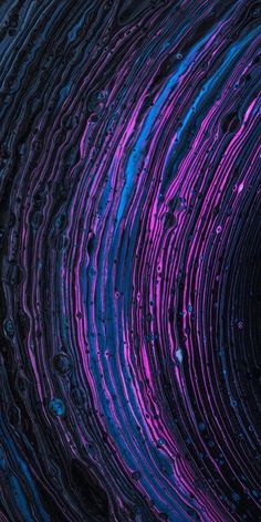 the inside of a blue and purple tube with water droplets