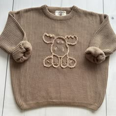 a knitted sweater with a teddy bear on it