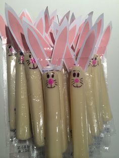 several plastic tubes with bunny ears on them and pink noses are lined up in front of each other