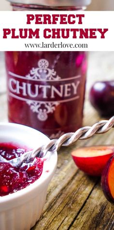 a jar of plum chutney next to some fruit