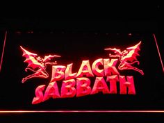 the black sababath logo is lit up in red and pink lights on a dark background