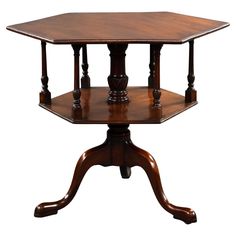 an octagonal wooden table with two pedestals on each side