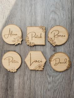 wooden name tags with flowers on them sitting on top of a piece of wood that says area, park, poto, plant