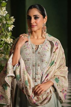 Ivory floral printed kalidar kurta with embroidered neckline and hem-line. Comes with coordinating salwar and embroidered dupatta with lace details. - Aza Fashions Cream Floral Print Kurta For Festive Season, Cream Floral Print Kurta For Festive Occasions, Elegant Pista Green Traditional Wear For Transitional Season, Elegant Transitional Pista Green Traditional Wear, Elegant Unstitched Suit With Intricate Embroidery In Pista Green, Elegant Banarasi Silk Anarkali Set With Chikankari Embroidery, Elegant Anarkali Set In Banarasi Silk With Chikankari Embroidery, Floral Embroidered Cotton Silk Lawn Suit For Wedding, Elegant Chanderi Churidar With Floral Embroidery