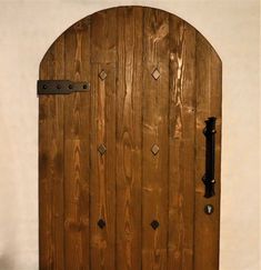 a wooden door with metal latches on the front and side doors are made out of wood