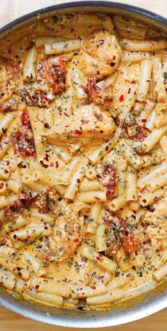 a pan filled with pasta and sauce on top of a table