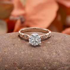 a diamond ring sitting on top of a rock