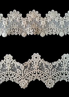 two pieces of white lace on black background