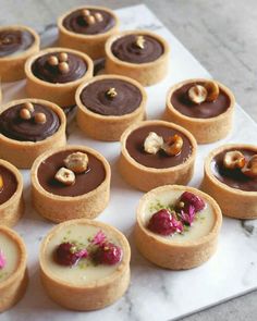 there are many small desserts on the table ready to be eaten and served together