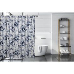 a bathroom with a shower, toilet and bathtub covered in a blue floral print