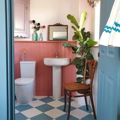 a bathroom with pink walls and checkered flooring on the floor is pictured in this image