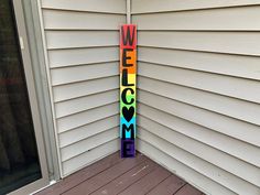 a wooden sign that says happy on the side of a house