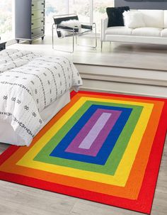 a brightly colored rug on the floor in a bedroom