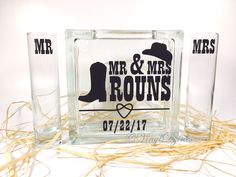 two shot glasses with mr and mrs rocks on the bottom one is clear, the other has black lettering