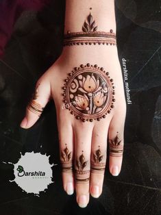 a woman's hand with henna tattoos on it