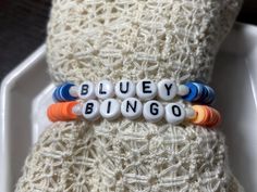 Handmade Heishi bead Bluey and Bingo kids bracelet set, size 6.5, stretchy with various blue beads for one and various orange beads for the other. This set would make a great gift for any Bluey fan! Bracelets Business, Heishi Bead Bracelet, Bingo For Kids, Kids Bracelet, Bluey And Bingo, Resin Bracelet, Kids Bracelets, Bead Ideas, Clay Bead