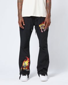 These flare pants are a bold and stylish addition to any wardrobe, featuring eye-catching flame and skeleton graphics on the front. The unique flare design offers a comfortable and relaxed fit, perfect for making a statement in any casual setting. Crafted from high-quality materials, these pants combine durability with a modern streetwear aesthetic. The adjustable drawstring waist adds functionality and style, making them a versatile choice for everyday wear. The back view provides a clean and s Jordan 4’s, Jordan Yeezy, Modern Streetwear, Nylon Pants, Streetwear Aesthetic, Jordans Women, Jordan 2, Mesh Shorts, Outerwear Coats