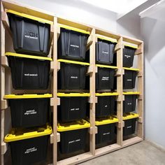 the shelves are filled with black and yellow bins