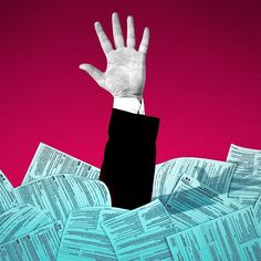 a man in a suit and tie holding his hand up above stacks of paper documents