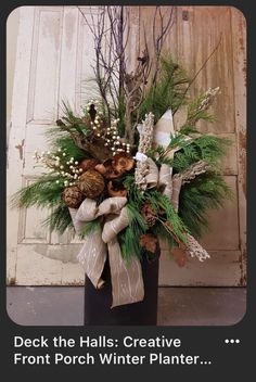 a vase filled with greenery and pine cones