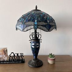 a blue lamp sitting on top of a wooden table