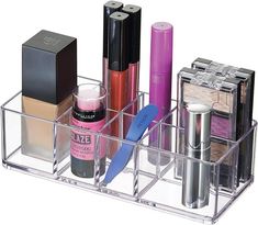 an assortment of cosmetics and makeup products in a clear holder