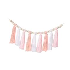 pink and white tasselled garland hanging from a string with wooden beads on it