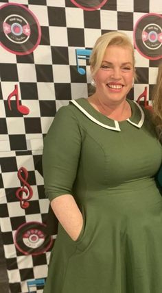 two women standing next to each other in front of a checkered wall